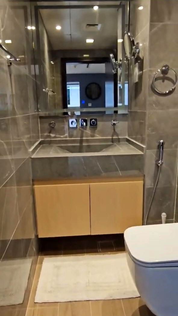 Bathroom with stone basin, wall-mounted mixer and concealed plumbing