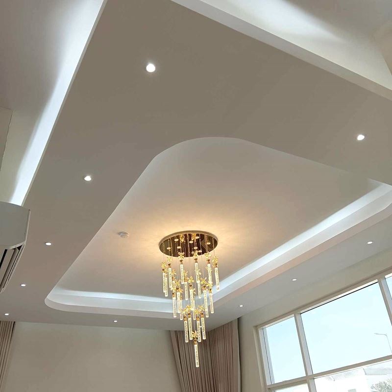 Finished gypsum ceiling with cove lighting, downlights and a crystal chandelier